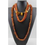 THREE BALTIC AMBER TYPE NECKLACES, and a coral necklace (4)