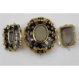 THREE VICTORIAN GOLD & SILVER MOUNTED MOURNING BROOCHES, one oval hair inset with tooled scrolls &