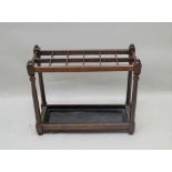 A FIRST-QUARTER 20TH CENTURY MAHOGANY FINISHED STICK STAND with multi-aperture top, supported on