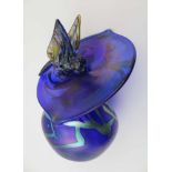 AN OKRA ART GLASS BY RICHARD GOLDING, in the form of a humming bird feeding from a Jack in the
