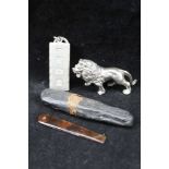 A CAST SILVER LION, 3cm high a silver ingot pendant, combined weight; 83g, together with a