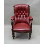 A WILLIAM IV MAHOGANY FRAMED LIBRARY ARMCHAIR with burgundy red leather upholstery, having part