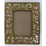 A CONTINENTAL CAST BRASS PHOTOGRAPH FRAME, decorated with fruiting brambles, stamped 'Harcourt', for