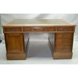 A LATE 19TH CENTURY OAK TWIN PEDESTAL PARTNERS DESK, having skiver insert top over three inline