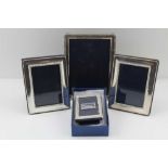 A COLLECTION OF FOUR SILVER MOUNTED PHOTOGRAPH FRAMES, to include one bound reed design to display