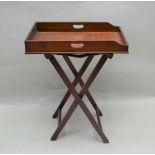A 19TH CENTURY MAHOGANY FINISHED BUTLER'S TRAY, the rectangular top having side handles, the whole