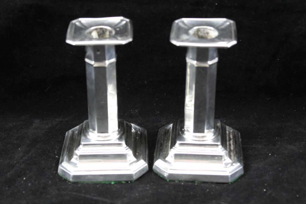 JAMES DEAKIN & SONS A PAIR OF SILVER CANDLESTICKS, octagonal stems on square stepped bases with