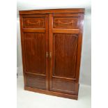 AN EDWARDIAN MAHOGANY TWO DOOR WARDROBE, inlaid bell husk decoration, 140cm x 197cm