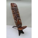 AN EARLY 20TH CENTURY CENTRAL AFRICAN CARVED WOOD BIRTHING STOOL, carved animal decoration,