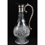 A CUT GLASS CLARET JUG with plated collar and handle, raised on circular star cut base, 30cm high