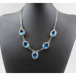 AN INDIAN WHITE METAL NECKLACE, inset five facet cut blue stones, 44cm long