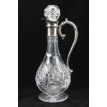A CUT GLASS CLARET JUG with plated collar and handle, raised on circular star cut base, 30cm high,