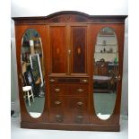 A LATE 19TH CENTURY INLAID MAHOGANY COMPACTUM WARDROBE, with two inlaid cupboard doors, over four