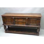 A JACOBEAN DESIGN REPRODUCTION OAK DRESSER BASE, having the quality of Titchmarsh & Godwin, with two