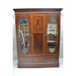 A FIRST-QUARTER 20TH CENTURY INLAID WALNUT WARDROBE having plain cornice over panelled central