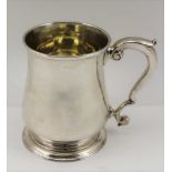 HENRY BRIND A GEORGE II SILVER HALF-PINT TANKARD of baluster form, scroll handle on circular