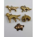 A COLLECTION OF FIVE YELLOW METAL CHARMS, two being an elephant and a dog both stamped .375 for