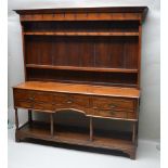 A 19TH CENTURY WELL PROPORTIONED OAK DRESSER with twin shelved plate rack back, having an array of