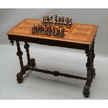 A VICTORIAN WALNUT CHESS TABLE with inset checker board top, two concealed in-line frieze drawers,