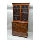 A FIRST QUARTER 19TH CENTURY MAHOGANY SECRETAIRE, the bookcase upper section having decorative