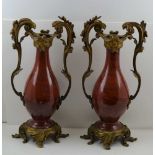 A PAIR OF FRENCH LOUIS XVI STYLE ORMOLU MOUNTED SANG-DE-BOEUF TYPE PORCELAIN VASES, of baluster