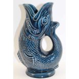 A 'DARTMOUTH' DEVON GLAZED POTTERY GURGLING FISH JUG, blue glazed, moulded with the inscription '