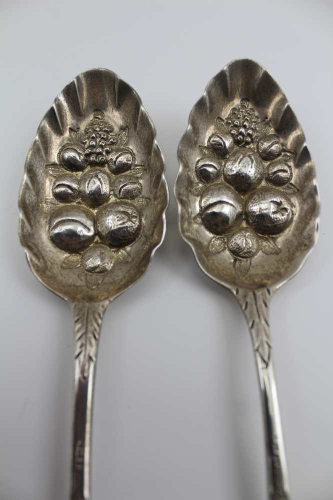 TWO GEORGE III SILVER BERRY SPOONS, repousse and chased decoration, London 1807 and 1817, combined - Image 2 of 4