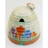 A CLARICE CLIFF CERAMIC BEE SKEP HONEY POT, the cover with moulded bee knop handle, the body painted
