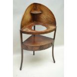 A 19TH CENTURY MAHOGANY CORNER WASHSTAND, with splash back, tier fitted drawer flanked by faux