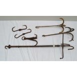AN EDWARDIAN IRON TACK CLEANING CEILING HOOK, the central adjustable pole with four hooks at angles,