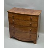 A 19TH CENTURY MAHOGANY BOW FRONT CHEST of four long graduated drawers, with turned knob handles,
