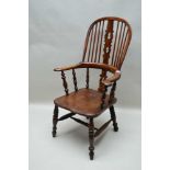 A 19TH CENTURY COMB & HORSESHOE BACKED ARMCHAIR with fancy shaped and pierced central slat, on