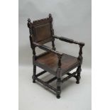 A 19TH CENTURY OAK DEEP SEATED CROMWELLIAN DESIGN ARMCHAIR supported on turned & blocked legs and
