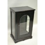 A LATER EBONISED TABLE TOP DISPLAY CABINET with single glazed door and sides, 71cm x 44cm