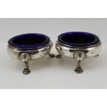 DAVID MOWDEN A PAIR OF MID 18TH CENTURY SILVER SALTS, raised on pad feet supports, with blue glass