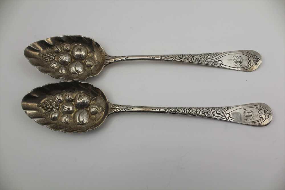 TWO GEORGE III SILVER BERRY SPOONS, repousse and chased decoration, London 1807 and 1817, combined