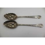 TWO GEORGE III SILVER BERRY SPOONS, repousse and chased decoration, London 1807 and 1817, combined