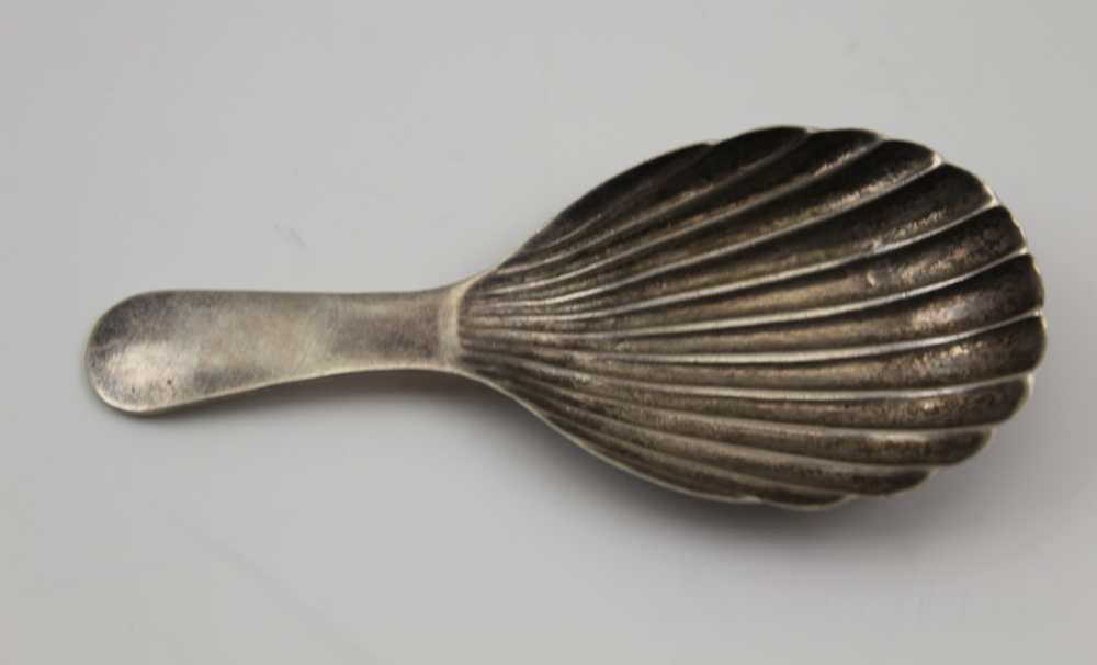 WILLIAM OSBORNE A GEORGE IV SILVER CADDY SPOON of scallop form, with plain handle. Dublin 1821, 13.