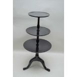 A 19TH CENTURY LATER EBONISED THREE-TIER DUMB WAITER 122cm high