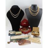 A QUANTITY OF COSTUME JEWELLERY to include; simulated pearls, brooches, earrings etc.