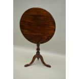 A 19TH CENTURY MAHOGANY CIRCULAR TOPPED TABLE on turned column and three downswept legs, 64cm x 53cm
