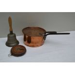 A CAST METAL HAND BELL with turned wood handle, 26cm high, together with a 19th century COPPER