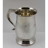 CHICK & SONS LTD. A GEORGIAN DESIGN SILVER PINT TANKARD of baluster form, on circular stepped