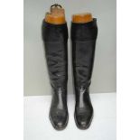 A PAIR OF BLACK LEATHER RIDING BOOTS with wooden trees