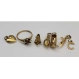 A COLLECTION OF 9CT GOLD CHARMS to include; a bowling pin, gondola, clog, pixie and a letter 'C',