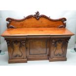 A LATE 19TH CENTURY MAHOGANY FINISHED SIDEBOARD with fancy carved and shaped upstand, having three