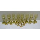 A SET OF EIGHT GREEN TINTED GLASS ROEHMERS with prunt decoration to the stems and conical bases,