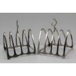 WILLIAM HAIR HASELER A PAIR OF SILVER TOAST RACKS, of gothic arch form, Birmingham 1935, combined