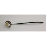 AN 18TH CENTURY TODDY LADLE, the bowl inset with a gilded George III 1787 shilling, having twisted