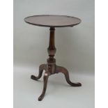 A 19TH CENTURY MAHOGANY CIRCULAR SAUCER TOPPED TABLE on baluster turned column and three downswept